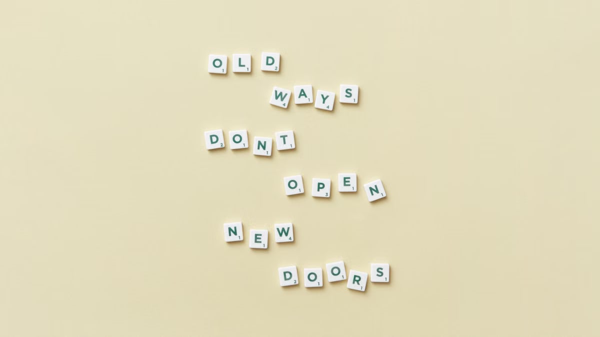Scrabble tiles arranged to display a motivational quote on a yellow background.